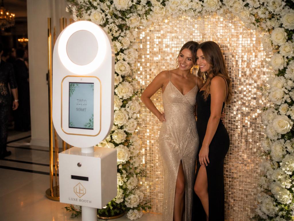 Selfie station photo booth with floral shimmer backdrop